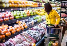 Do Government Groceries Really Work? Woman in a yellow coat shopping for fruits in a supermarket