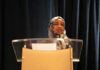 Deportation Showdown: Trump Targets Omar Woman in hijab speaking at a podium