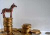Why Democrats Are Losing Cash Plastic donkey figurine on a stack of coins