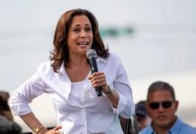 woman speaking into a microphone at an outdoor event