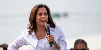 woman speaking into a microphone at an outdoor event