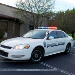 Police Captain Faces Charges After Toddler Found Police car with flashing lights parked outside a building