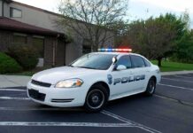 Police Captain Faces Charges After Toddler Found Police car with flashing lights parked outside a building