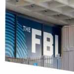 FBI Eases Prostitution Hiring Rule FBI sign on building facade behind metal fence