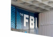FBI Eases Prostitution Hiring Rule FBI sign on building facade behind metal fence