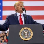 Power Play: Trump Puts Johnson On Top speaker at podium with U.S. flag backdrop