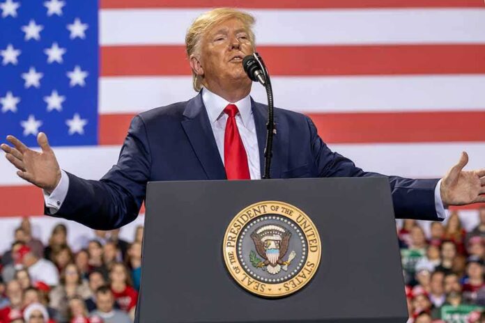 shutterstock_1677446302 speaker at podium with U.S. flag backdrop