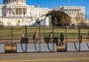 Power Grab? DOJ Muzzles D.C. On Troops Soldiers stand behind a security fence near a large government building