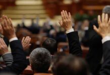 Parents’ Rights Brawl Roils Virginia Raised hands in a formal meeting or vote