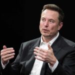Musk Money Tsunami Targets Texas man in a suit speaking with hand gestures