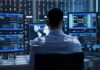 Trading Firms Pay For First Dibs On Trump IT professional monitors multiple screens in a server room