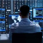 Trading Firms Pay For First Dibs On Trump IT professional monitors multiple screens in a server room