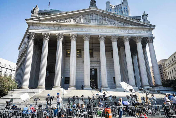 2445868619 Reporters and photographers gathered outside a neoclassical courthouse