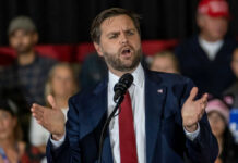 Gym Showdown Dares The Vice President Man in suit speaking at a podium