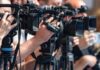 television cameras on tripods at a media event