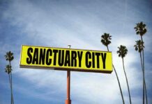 Sanctuary Over? Blakeman Drops Hammer Yellow roadside sign reading Sanctuary City with palm trees