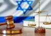 Gavel and scales of justice with Israeli flag in background