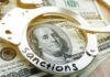 Handcuffs on U.S. hundred-dollar bills