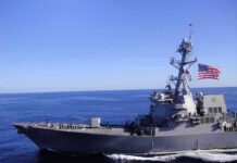 Eight Sailors Hit Breaking Point Naval destroyer sailing on open sea with flag flying
