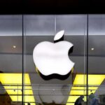 Apple Handoff Sparks Big AI Questions Apple logo on glass storefront
