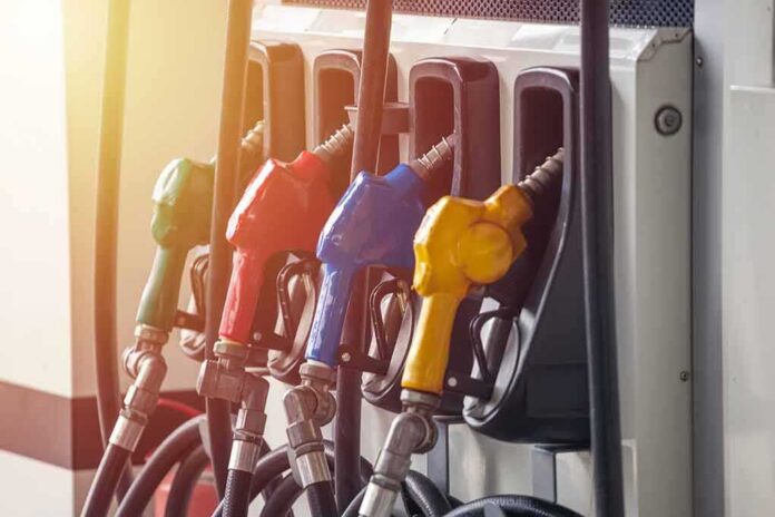 shutterstock_1195443886 Fuel pump nozzles in multiple colors at a gas station