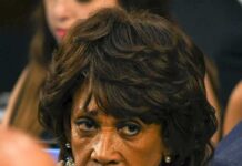 Inflation Blame Game Explodes In Hearing woman with serious expression in a crowd