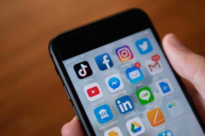 shutterstock_1272517939 Smartphone screen with social media and messaging apps
