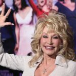 Violent Threats Alleged In Dolly Feud Dolly Parton waving at an event