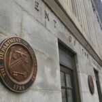 New Sanctions Hit Iran’s Global Money Network U.S. Treasury building exterior with bronze seal on stone wall