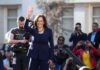 Kamala Harris waves to a crowd at an outdoor event