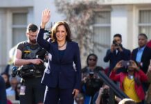 Detroit Power Move Hints At Bigger Stakes Kamala Harris waves to a crowd at an outdoor event
