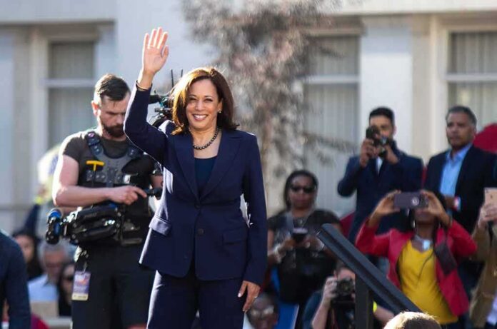 shutterstock_1296858898 Kamala Harris waves to a crowd at an outdoor event