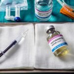 Medical tray with syringe and pentobarbital vials on gauze