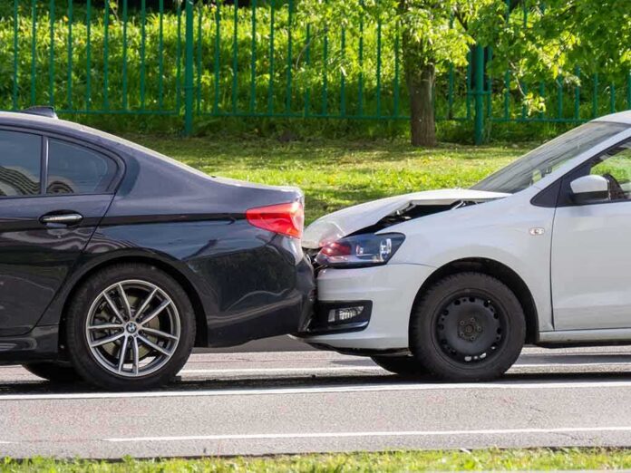 shutterstock_1470191021 Rear-end collision between two cars on a city street