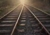 Railway tracks converging into the distance at sunset