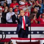 Trump Opens October With Two Red-State Rallies Donald Trump points from a rally stage; Rudi Koertzen and Bear Pascoe are in the crowd