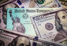 United States Treasury check on top of US dollar bills