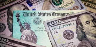 United States Treasury check on top of US dollar bills