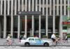 Random Stabbing Shocks Times Square News Corporation building entrance with NYPD car and cyclists