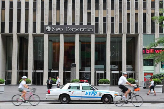shutterstock_169388615 News Corporation building entrance with NYPD car and cyclists