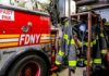 fire truck and hanging firefighter gear in a station