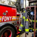 fire truck and hanging firefighter gear in a station