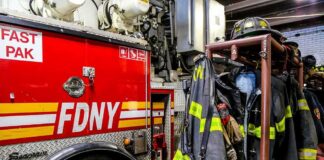 fire truck and hanging firefighter gear in a station