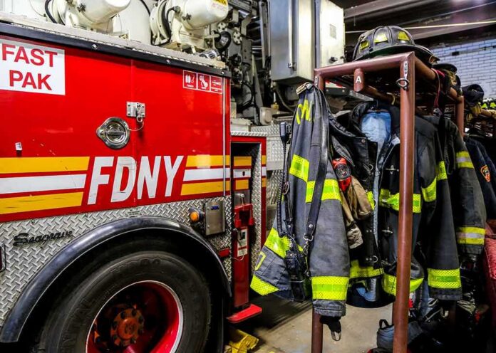 fire truck and hanging firefighter gear in a station
