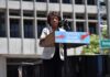 Democratic Feud Draws Media Attack speaker at outdoor rally podium