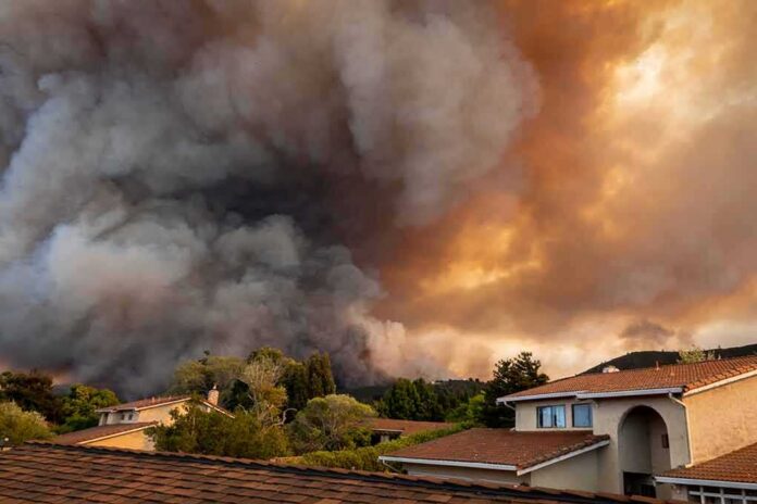 shutterstock_1801300195 Wildfire smoke billows over suburban houses