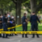 Gazebo Killing Sparks Rapid Arrest crime scene tape with police officers in a park