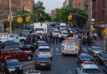 Downtown Gunfire Hammers Police Police vehicles and officers block a city street during an active scene
