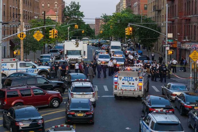 shutterstock_1976471648 Police vehicles and officers block a city street during an active scene