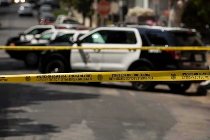 Police tape cordoning off street with patrol SUVs behind